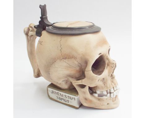 Coloured bisque stein modelled as a human skull with pewter mounts, 17cm high including thumb piece  Condition - good