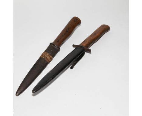 Two old German trench boot knives with wooden handles and steel blades, the longest 29cm including scabbard  one has piece of