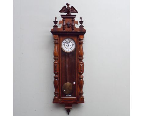 Vienna striking wall clock in walnut case with eagle finial