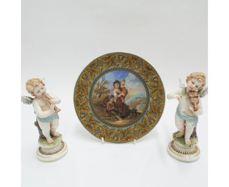 Prattware plate decorated with group of children in a landscape scene and a pair of Capo di Monte musical cherubs 