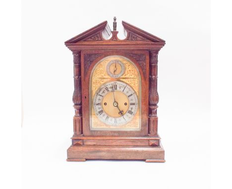 Late Victorian mahogany striking bracket clock in decorative walnut case with arched brass dial