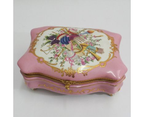 Continental large porcelain trinket box, pink ground decorated with musical instruments, fruit, flowers and gilding appx 20cm