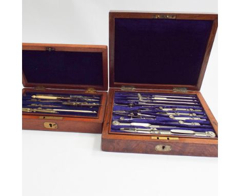 Old technical drawing set in a figured walnut box, some pieces stamped Army and Navy and a smaller technical drawing set in a