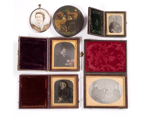 A COLLECTION OF FOUR VICTORIAN AMBROTYPE PHOTOGRAPHS, family portraits in folding leather cases, an early 20th Century oval m