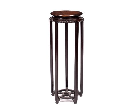 A CHINESE BURR HARDWOOD STAND with carved scroll decoration and on four supports, 87cm high x 30cm diameter