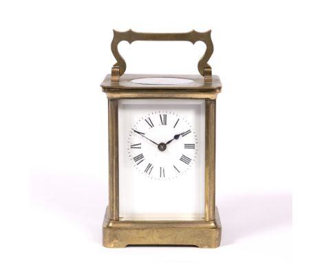 A FRENCH BRASS CASED CARRIAGE TIMEPIECE with enamel dial and Roman numerals, 10.5cm high