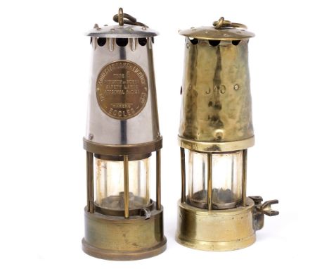 A PRESENTATION MINER'S LAMP by the Protector Lamp & Lighting Company Ltd, Eccles, 23cm high; and another old brass and glass 