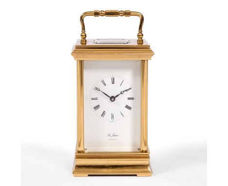 A MODERN ENGLISH CARRIAGE TIMEPIECE with lacquered brass case and white enamel dial by St James London, 12.5cm high, plus lin