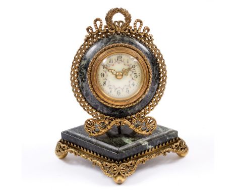 A FRENCH GREEN MARBLE AND GILT METAL TIMEPIECE with painted enamel dial, ribbon swag ornament and shaped stepped base, 15cm h