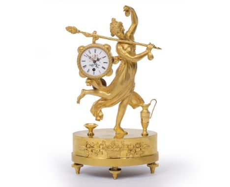 A FRENCH EMPIRE ORMOLU MANTEL TIMEPIECE the white enamel Roman dial with polychrome floral decoration, the circular movement 