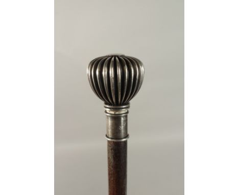 AN EDWARDIAN WALKING CASE with silver pommel top. 92cms long.