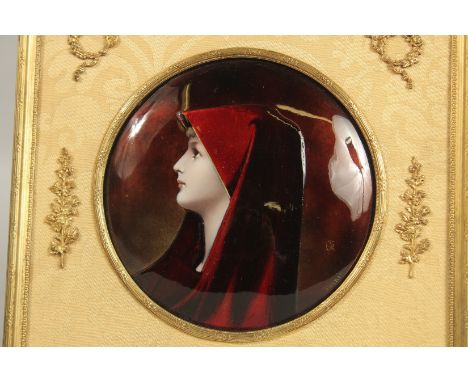 A GOOD 19TH CENTURY FRENCH LIMOGES ENAMEL CIRCULAR HEAD AND SHOULDERS OF A YOUNG GIRL, monogrammed, 14cms diameter, in a gilt