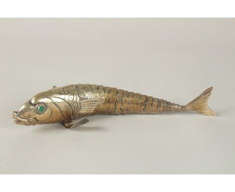  A LARGE GILDED SILVER FLEXIBLE FISH with coloured stone eyes. 27cms long.