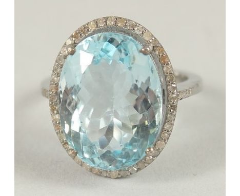 A SILVER BLUE TOPAZ AND DIAMOND RING.