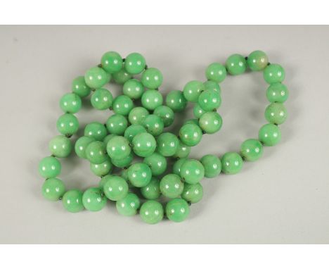 A STRING OF JADE BEADS. 90cms long.