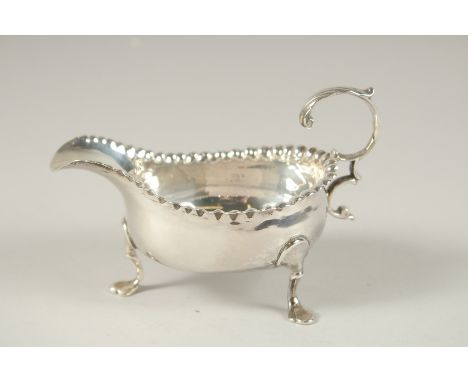 A SMALL GEORGE III SILVER SAUCEBOAT on three pad feet. London 1769.