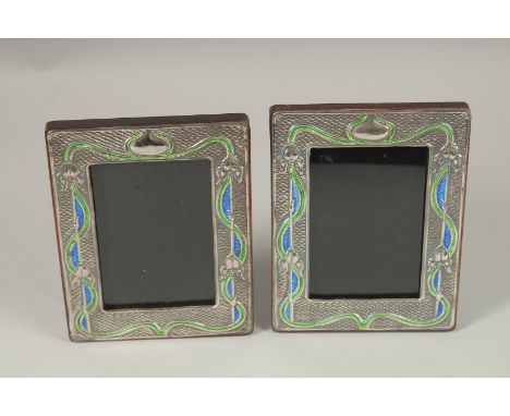 A PAIR OF SILVER AND BLUE ENAMEL PHOTOGRAPH FRAMES. 20cms x 14cms.