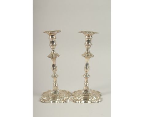 A PAIR OF GEORGE III SILVER CAST CANDLESTICKS by W. CAFE with cast shell bases, 26cms high. London 1758. Weight 40ozs.