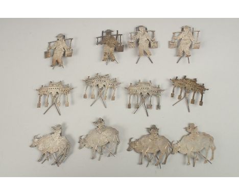 A SET OF TWELVE CHINESE SILVER CARVINGS.