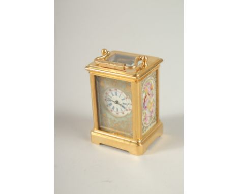 A TINY BRASS CARRIAGE CLOCK with pink porcelain sides. 6cms high.