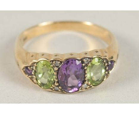 A 9CT GOLD PERIDOT, AMETHYST AND DIAMOND RING.