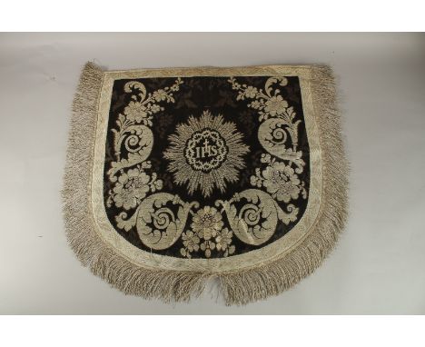 A SILVER THREADED IHS TEXTILE. 58cms x 58cms.