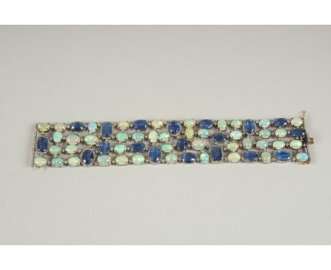 A GOOD SILVER SET OPAL, DIAMOND AND TANZANITE BRACELET with gold clasp.