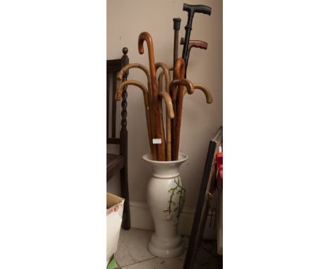 Stick stand with a collection of walking sticks.