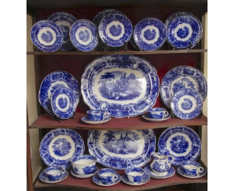 3 shelves of blue and white plates, platters, cups and saucers of similar designs.