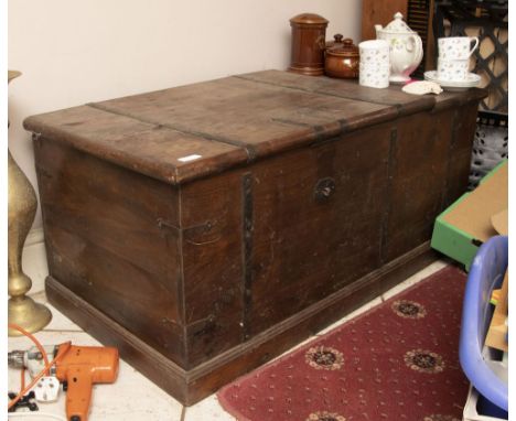 A large wooden wine trunk with iron banding. The lid opens 3/4 of the surface.