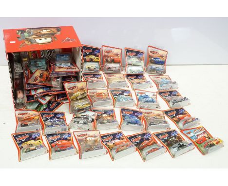 57 Carded Mattel Disney Pixar Cars diecast models, all ex, contained within a Cars storage box. 