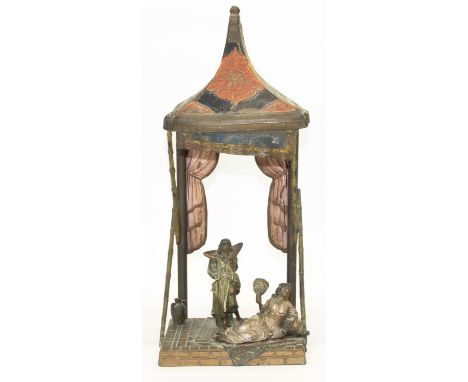 After Franz Bergman: a painted spelter table lamp in the form of two females on rugs on tiled floor under a draped canopy, H3