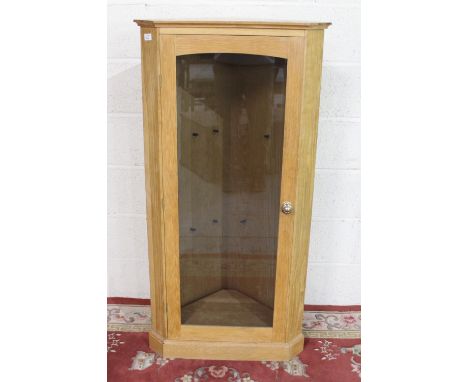 Light oak corner cabinet, glazed door with two shelves on plinth base, W65cm D40cm H129cm 