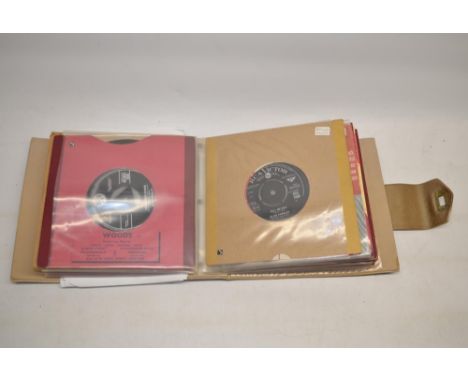 Collection of twenty four Elvis Presley 45 RPM records from late 1950's, produced by RCA, some in original sleeves and pictur