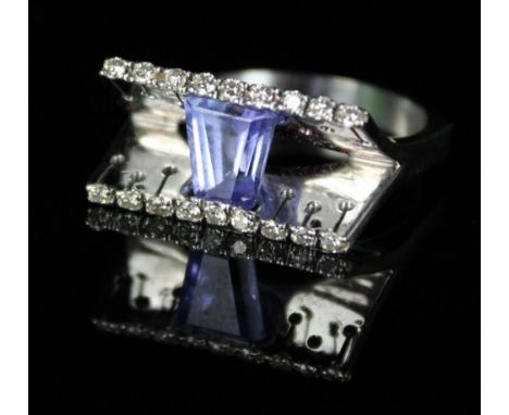 Modernist amethyst and white metal designer dress ring, the tapered baguette cut amethyst suspended between flared pave diamo