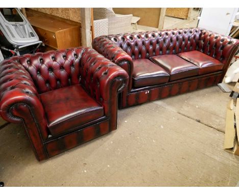 Red leather Chesterfield three seater sofa with buttoned back, together with a similar armchair