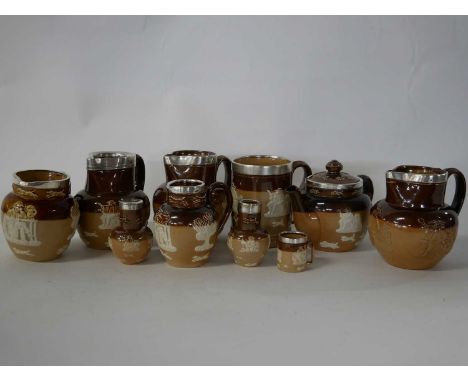 Group of Doulton Lambeth harvest wares, all with silver rims, comprising tea pot, four jugs of varying sizes, a mug, pepper p