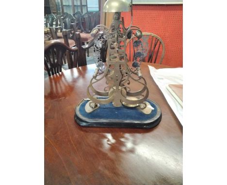 Late 19th/early 20th century skeleton mantel clock with blue and white enamel highlighted face, set on an ebonised plinth bas