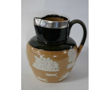 Large Royal Doulton jug with buff coloured sprigged decoration below a green coloured neck and large silver rim with London h