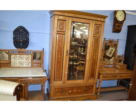 A Victorian ash and inlaid bedroom suite comprising a mirrored door wardrobe, a dressing table with adjustable mirrored back 