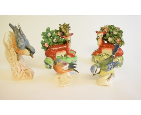A pair of Staffordshire pottery stag and doe figures, damages, the stag 12 cm high, and three Goebel birds (5)