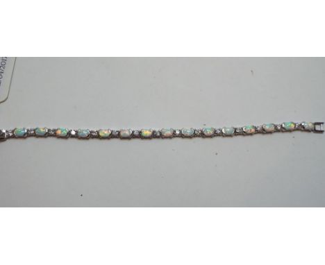 A silver coloured metal and opal bracelet, a similar ring (2) 