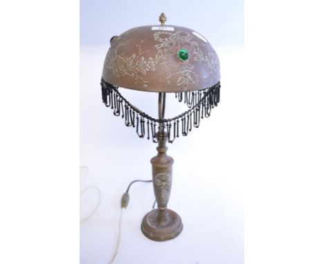 An early 20th century Continental brass lamp and shade, decorated foliage, 45 cm high
