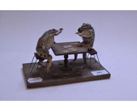Taxidermy: Manner of Walter Potter, a pair of toads anthropomorphically modelled seated playing cards