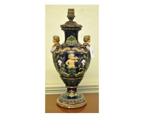 A pottery lamp, decorated putti, 35 cm high (over fitment)   Condition report  Report by RBA couple of minor chips