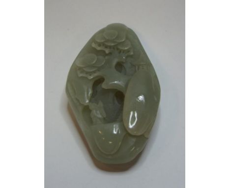 A carved jade pebble, 8 cm high 