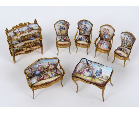 A Viennese enamel and gilt metal doll's house suite, comprising a three tier etagere, 8.5 cm high, a table, 5.5 cm high, two 