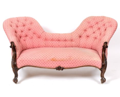 A Victorian rosewood button back two seater settee, on leaf carved cabriole front legs with scroll feet  See illustration