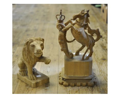 A carved newel post finial, in the form of a rampant unicorn and an armorial, 36 cm high, a similar carving of a lion, 26 cm 