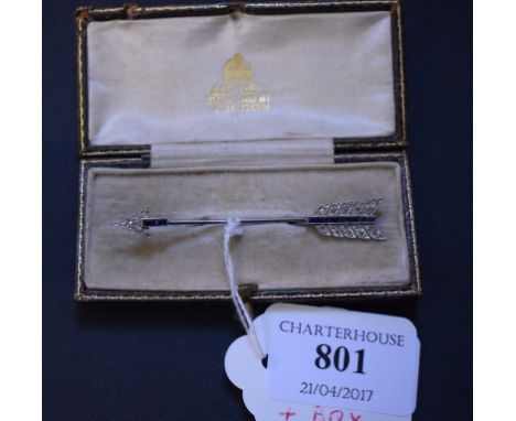 A yellow and white coloured metal arrow brooch, set diamonds and sapphires, in an Asprey box